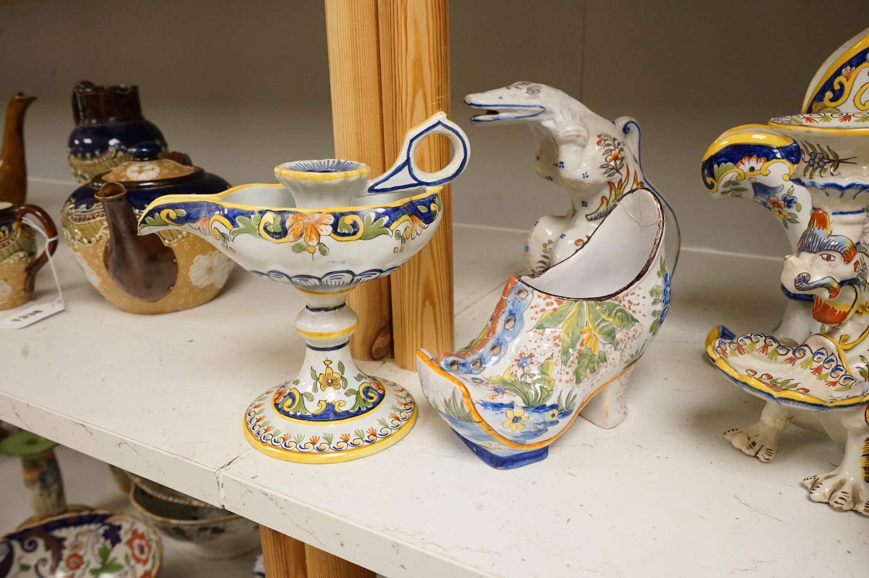 A group of French faience pottery to include spill vases, an ink well and dishes, largest 21cm high